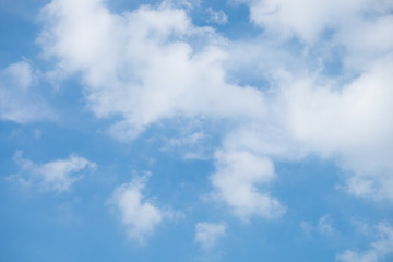 White Clouds on the bright sunny blue sky. Nature background.