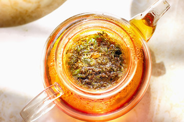 glass teapot for tea with hot herbal tea. Hot wholesome tea.   a cure for the flu