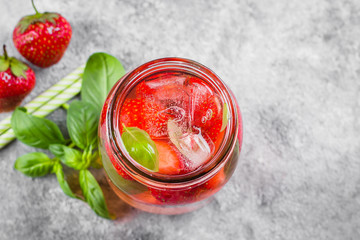 Summer Food and Drink. Mason Jar with strawberry basil lemonade on concrete table. Copy space