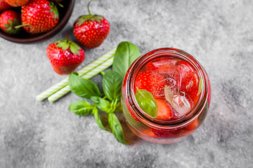 Summer Food and Drink. Mason Jar with strawberry basil lemonade on concrete table. Copy space