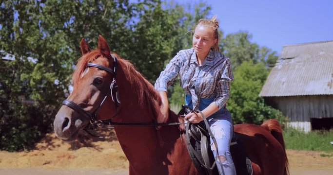 Woman slowly rides a ranch