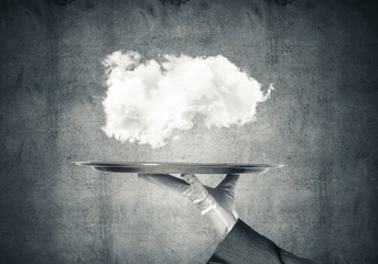 Hand of waitress presenting cloud on tray.