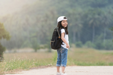 explorer kid girl walking with backpack hiking