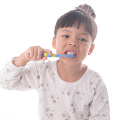 Little girl brushing her teeth isolated on white background