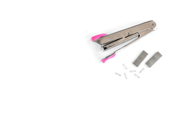 Pink stapler and brackets isolated on a white background.