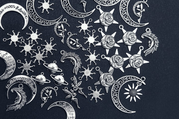 Charm pendants for crafting. Sun and moon symbols. Star and planet figures.