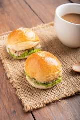 tuna burger and coffee on wood background.