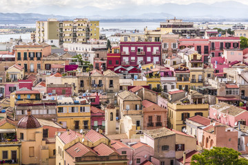 Colorful mediterranean houses of Cagliari old town in warm shades of yellow, orange and pink,...