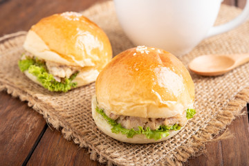 tuna burger and coffee on wood background.