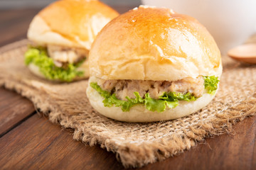 tuna burger and coffee on wood background.