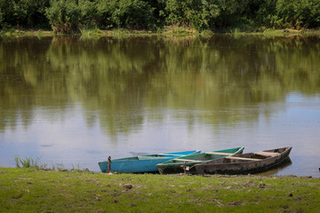 Pair of traditional wood boat on the river boat Desna in Ukraine