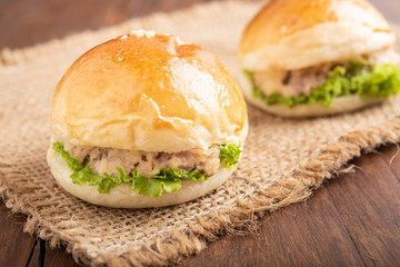 tuna burger and coffee on wood background.
