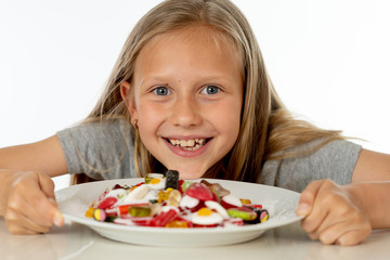 sugar high young blonde girl eating too much sugar in nutrition concept