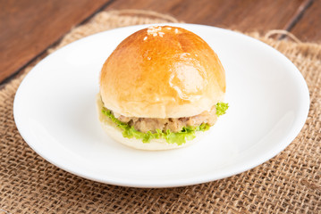 tuna burger and coffee on wood background.