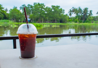 The Black coffee cool on the table, white in a restaurant on the raft.