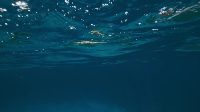 Blue ocean water surface half-water shot