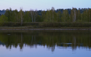 Obraz premium reflection of green forest in the river
