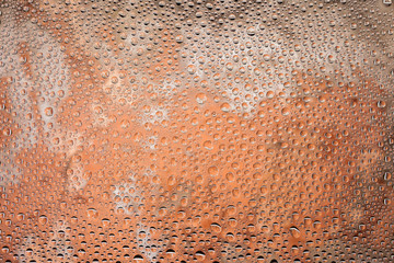 Close up of a water drops on a red old brick background, covered with drops of water -condensation.