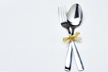 Fork and spoon with ribbon