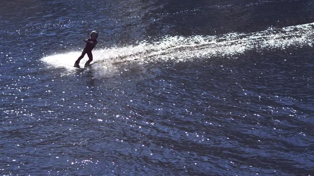 Child on water skiing. Kid wakeboarding. Children extreme sport. Boy riding on wakeboard. Child exercising water skiing. Healthy life. Water sports in childhood