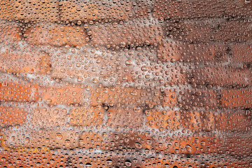 Close up of a water drops on a red old brick background, covered with drops of water -condensation.