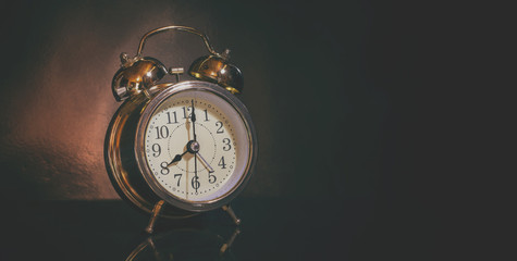 analog system alarm clock old in dark room dim light / photo vintage style and selective focus