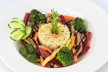 Risotto with vegetables and sliced meat 