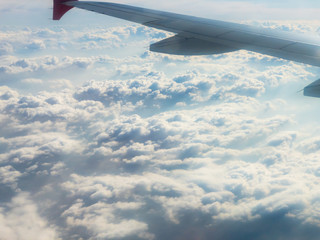 Fototapeta premium Flying above the clouds by the airplane