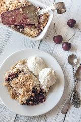 Portion of berry crumble with vanilla ice cream