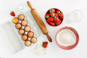 Flat lay set raw ingredients cooking strawberry pie cake white background Eggs flour milk sugar...