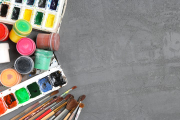 Paints for drawing and brushes on the table