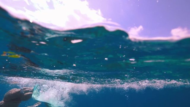 A girl learing how to dive with fins in sea 