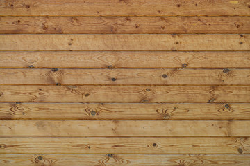 wall of wooden planed logs square section