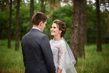 Fototapeta premium Bridal couple holding each other just after the wedding ceremony.