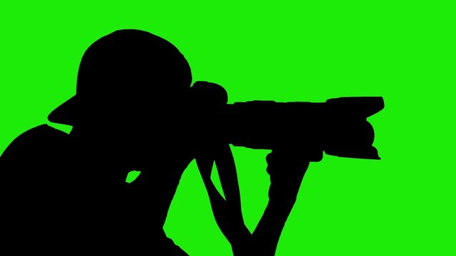 Black shape silhouette man photographer with professional camera shooting concert on green screen background