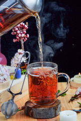 A fragrant flower tea on a table with flowers