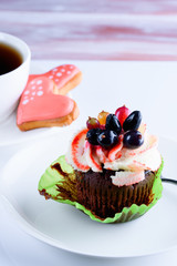 Sweet and tasty cake with cookies on white background