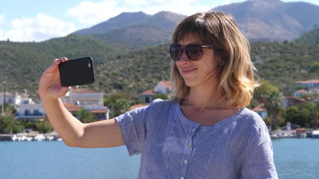 Young woman enjoy take phone selfie while summer leisure on Greece Thassos sea resort