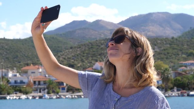Young woman enjoy take phone selfie while summer leisure on Greece Thassos sea resort