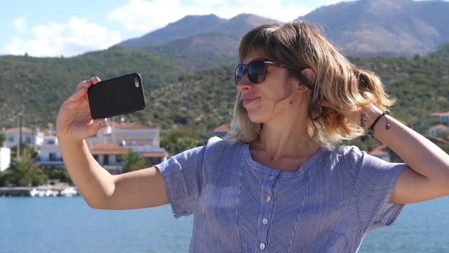 Young woman enjoy take phone selfie while summer leisure on Greece Thassos sea resort