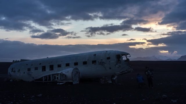 Sunset Timelapse of tourists climbing on wrecked DC3