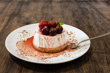 Pavlova meringue cake with fresh berries on wooden table background