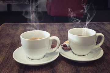 coffee cups on wood table in cafe