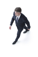 Top view confident businessman goes forward.
