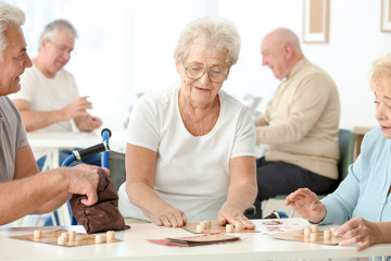 Senior people playing lotto at care home