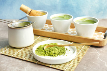 Plate with powdered matcha tea and chashaku on table