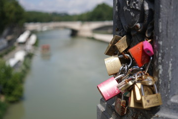 Close-up on the love padlocks mounted by a bridge over the Tiber river in Rome, Italy. Selective...