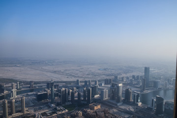 Dubai, United Arab Emirates -November 5, 2015: Aerial view of Downtown Dubai shooting through the glass window  from the tallest building in the world  , Burj Khalifa.