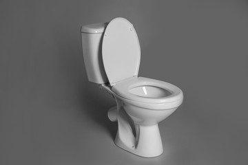 New ceramic toilet bowl on grey background