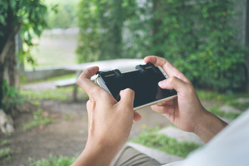 close up of hands playing game on smartphone